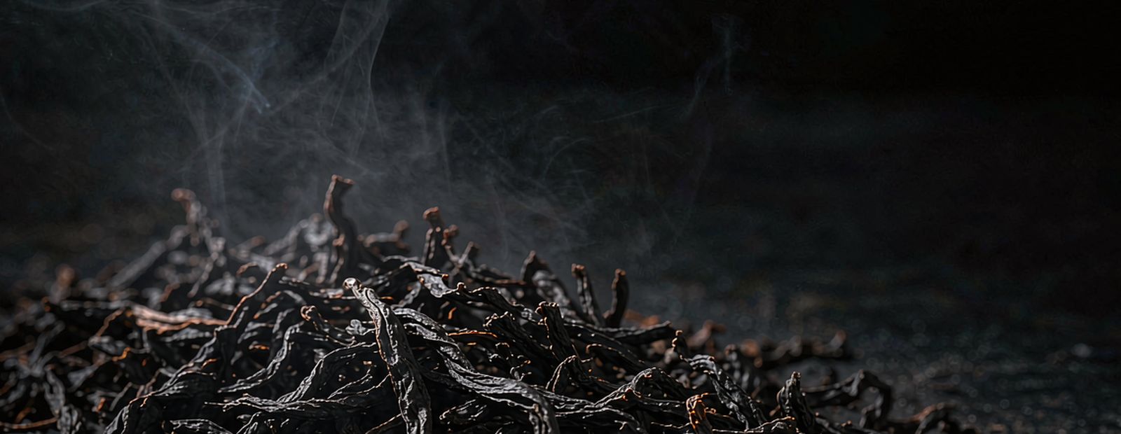 Close view of a clay teapot and bamboo tea scoop on aged wood