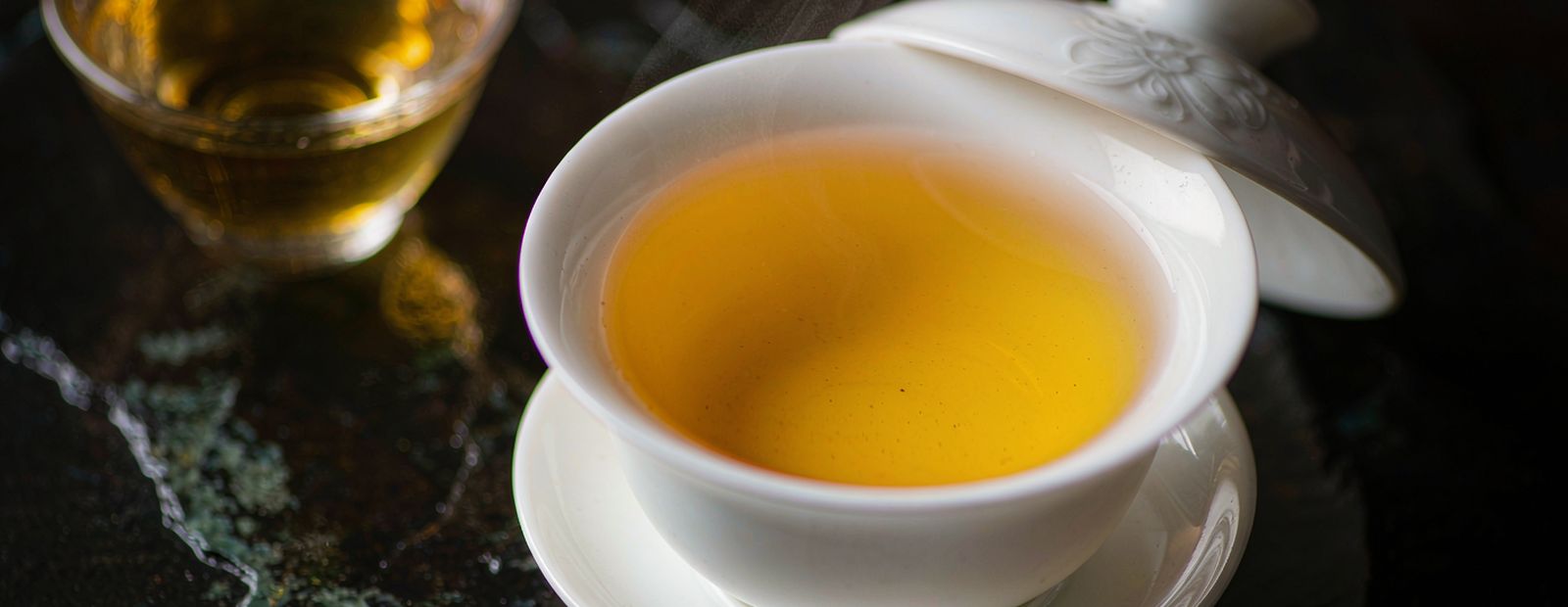 Dancong oolong leaf, long twisted strands with visible tips in a dark dish